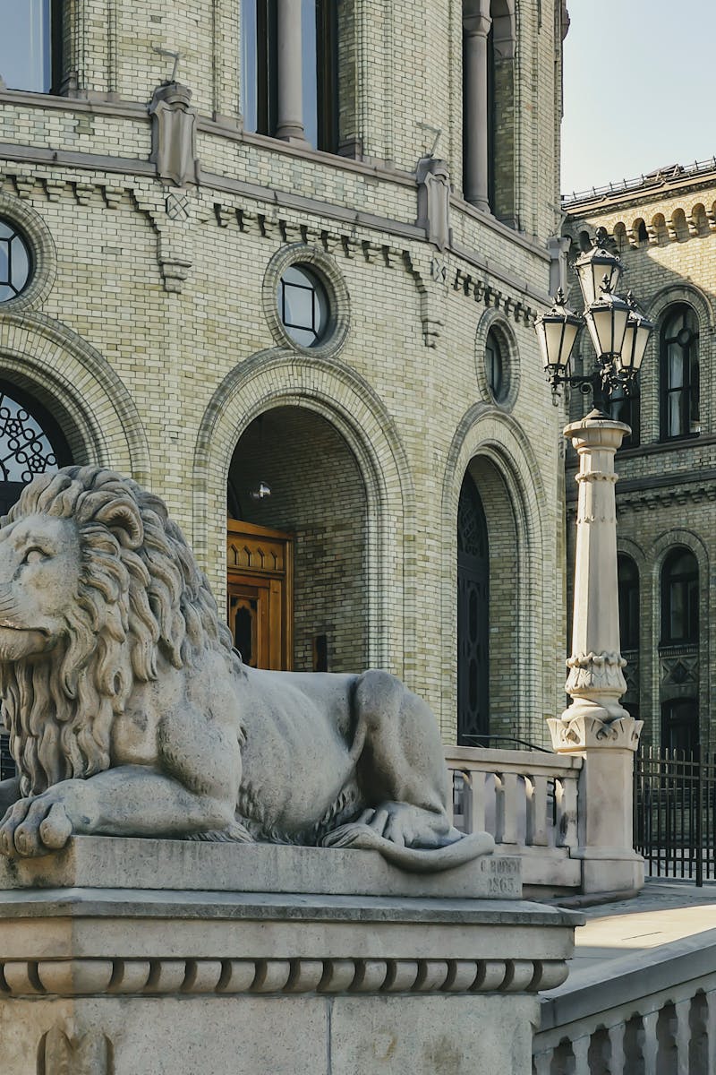 Lion sculpture at grand historic building facade in urban setting